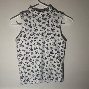 A low turtle neck blouse, small, white with blue flower print.